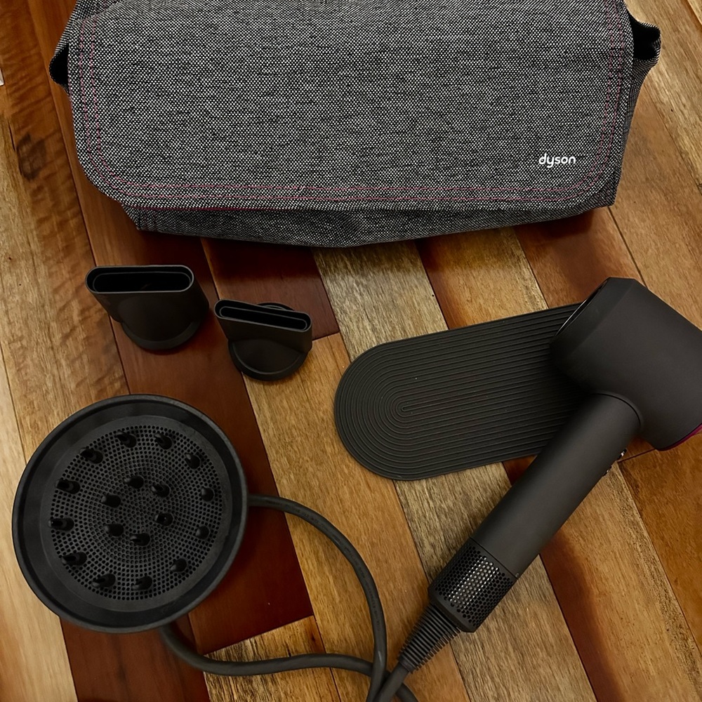 Dyson Supersonic Hair Dryer with attachments and case.